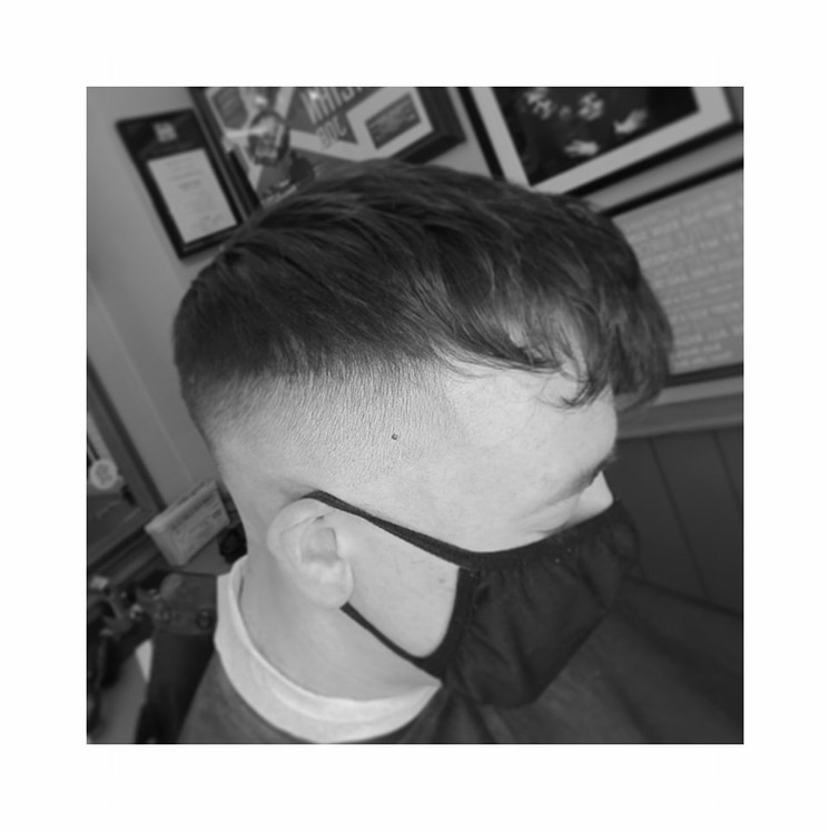 Black and white close-up of a finished fade haircut