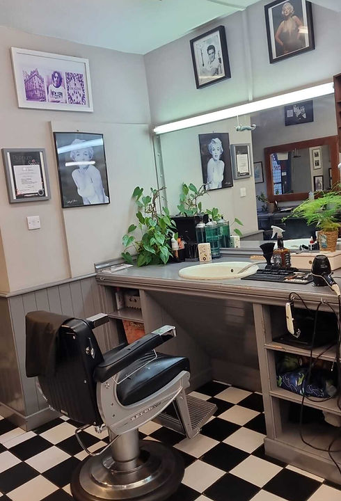 The Legends shop interior with barber chair, mirror and black-and-white floor