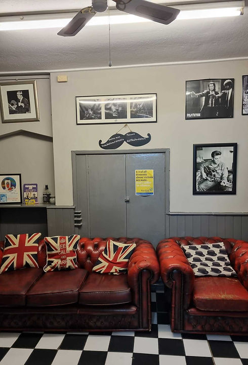 Waiting area with red sofa, Union Jack cushions and vintage decor